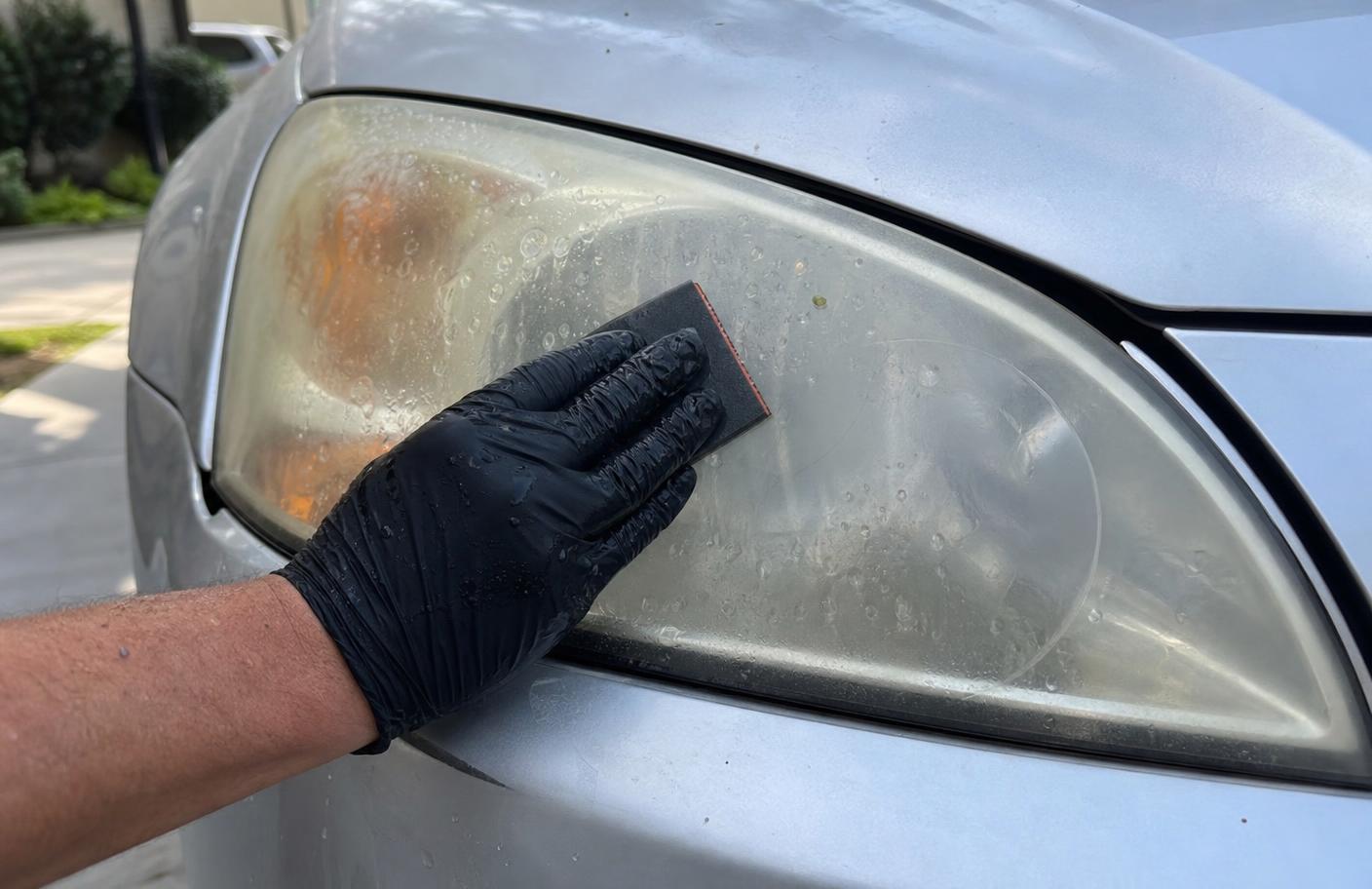 Car headlight shown half yellowed and half restored to clear after polishing